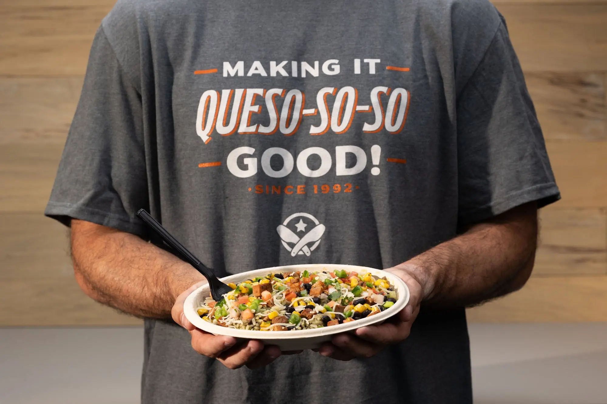 Pancheros employee holding a burrito bowl