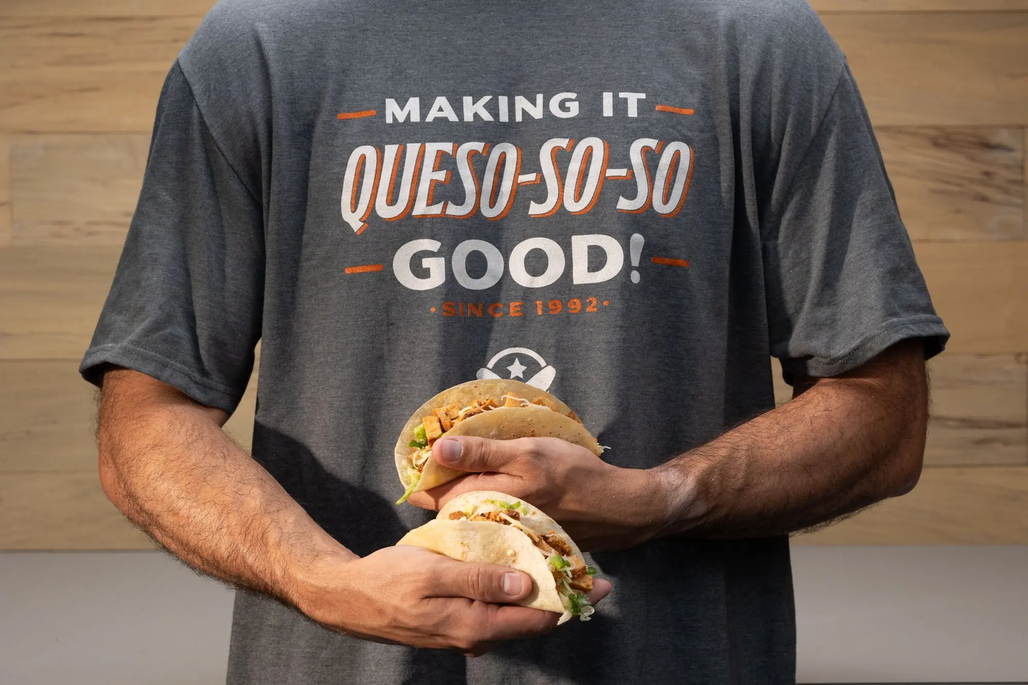 Pancheros employee holding tacos