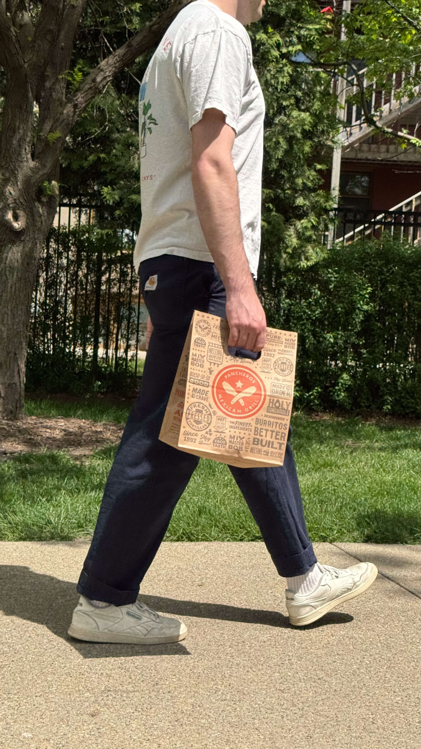 Man walking with Pancheros to go bag