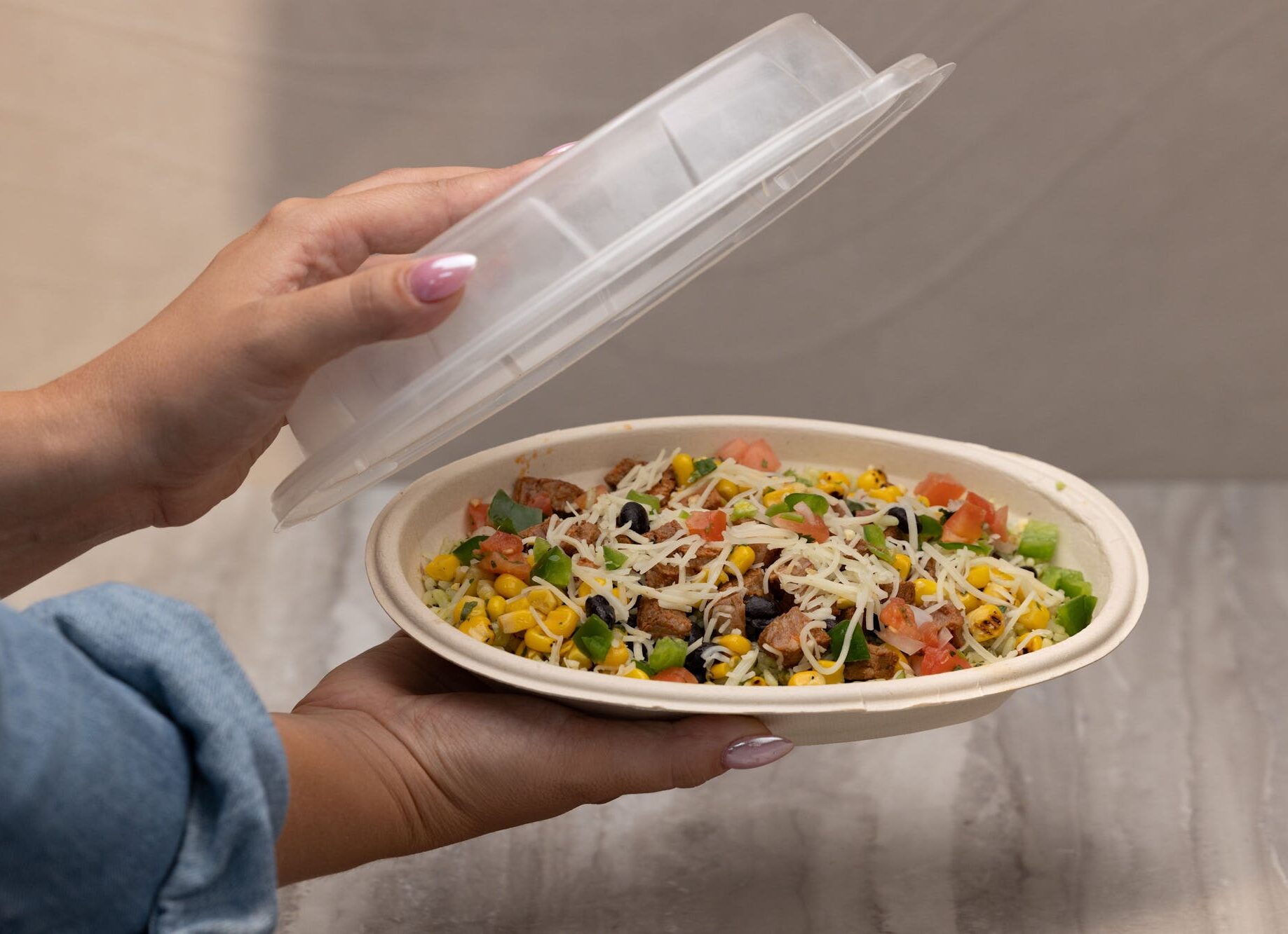 Opening the lid on a Pancheros burrito bowl