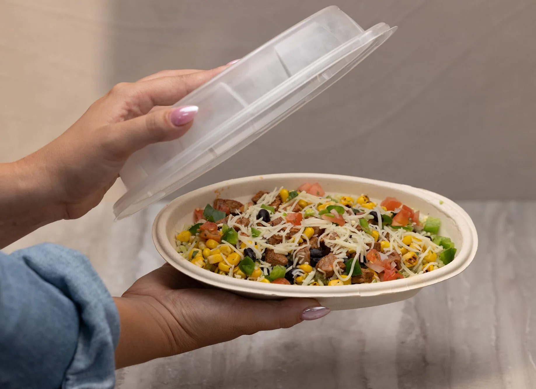 Opening the lid on a Pancheros burrito bowl