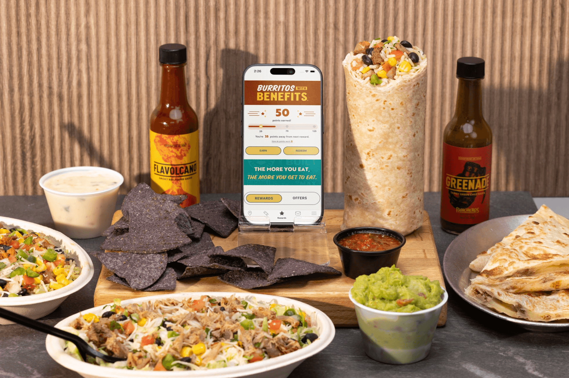 Pancheros foods surrounding a phone with the Pancheros app